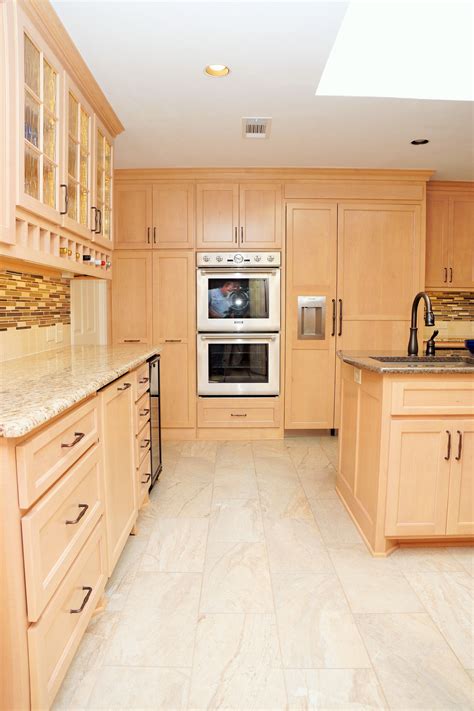 stainless steel appliance in light or dark wood cabinets|kitchen with light wood cabinets.